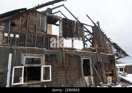 Burnt wooden house. House after the fire. Burned brick house with burnt roof inside view Stock Photo
