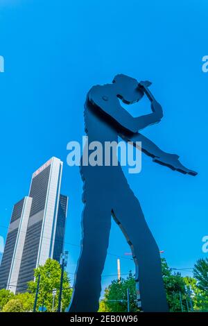 FRANKFURT, GERMANY, AUGUST 18, 2018: Statue of a hammering man, designed by jonathan borofsky, near Messeturm, Frankfurt, Germany Stock Photo