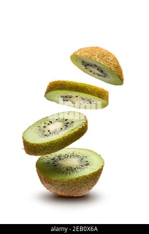 sliced kiwi fruit flying on white background Stock Photo