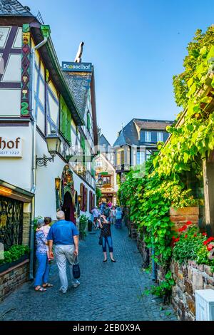 RUDESHEIM AM RHEIN, GERMANY, AUGUST 16, 2018: Tourists are strolling through famous Drosselgasse street in Rudesheim am Rhein in Germany Stock Photo