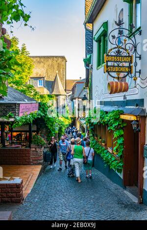 RUDESHEIM AM RHEIN, GERMANY, AUGUST 16, 2018: Tourists are strolling through famous Drosselgasse street in Rudesheim am Rhein in Germany Stock Photo