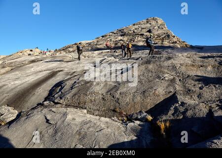 Climbers make their way down from Low’s Peak, the mountain’s highest point,  Mount Kinabalu, Sabah, Malaysia, Borneo Stock Photo