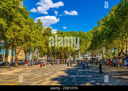 COLOGNE, GERMANY, AUGUST 11, 2018: People are enjoying a sunny day on Neumarkt square in Cologne, Germany Stock Photo