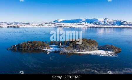 Kinross, Scotland, UK. Aerial view of a snow covered Lochleven Castle situated on small island on Loch Leven, Kinross-shire. Stock Photo