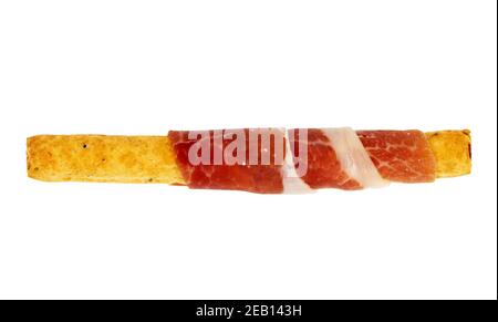 Parma ham prosciutto or spanish jamon with grissini breadsticks isolated on white background. Stock Photo