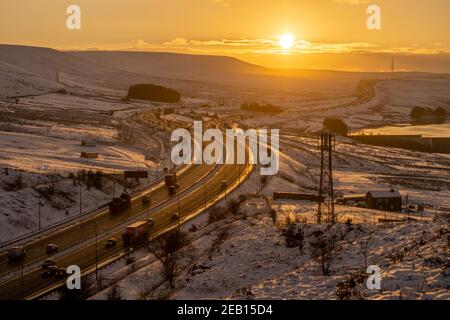 Sunset over the M62 motorway in winter, looking west from Scammonden bridge towards the summit which is 372m above sea level. England's highest m'way Stock Photo