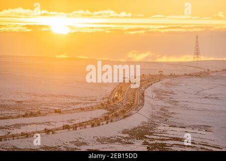 Sunset over the M62 motorway in winter, looking west from Scammonden bridge towards the summit which is 372m above sea level. England's highest m'way Stock Photo