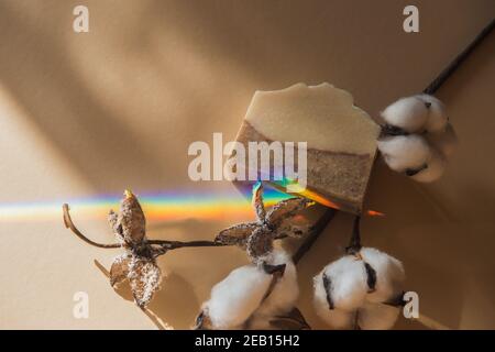 Handmade soap, cotton branch and rainbow on beige background. Zero waste, eco friendly cosmetics concept Minimalism flat lay composition for bloggers, Stock Photo