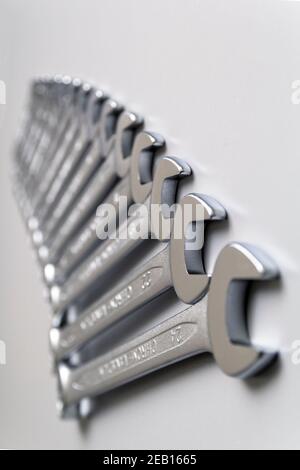 Cut-out wrenches horizontally placed from the biggest to the smallest in a row. Top view composition. Hand tool. Tools for carpentry work. Type of fas Stock Photo
