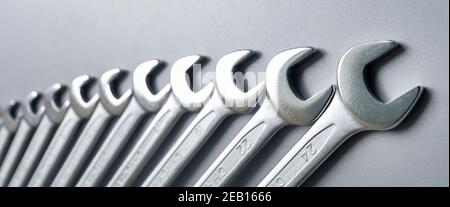 Cut-out wrenches horizontally placed from the biggest to the smallest in a row. Top view composition. Hand tool. Tools for carpentry work. Type of fas Stock Photo
