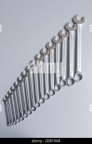 Cut-out wrenches horizontally placed from the biggest to the smallest in a row. Top view composition. Hand tool. Tools for carpentry work. Type of fas Stock Photo
