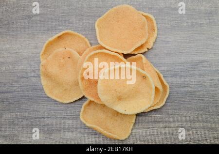 prawn crackers isolated on wooden background Stock Photo