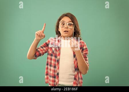 fully inspired child. school girl got an idea. childhood happiness. child in good and positive mood. looking smart in glasses. small girl inspired by Stock Photo