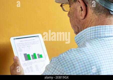 White man with a white engineer helmet holding a tablet Stock Photo