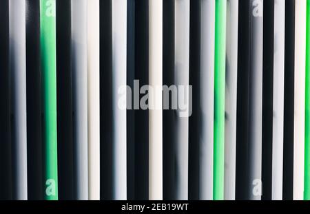 Background with gray, black and green jalousie straight vertical lines Stock Photo
