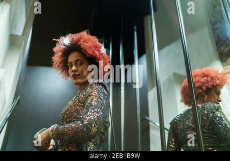 beautiful woman with afro hair reflected in the mirror Stock Photo