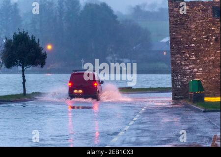 Timoleague, West Cork, Ireland. 11th Feb, 2021. After a day of torrential rain and winter showers, the road under Timoleague Abbey flooded at high tide this evening. Credit: AG News/Alamy Live News Stock Photo