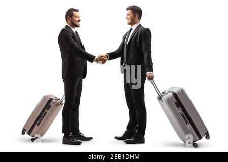 Two young businessmen with suitcases shaking hands isolated on white background Stock Photo