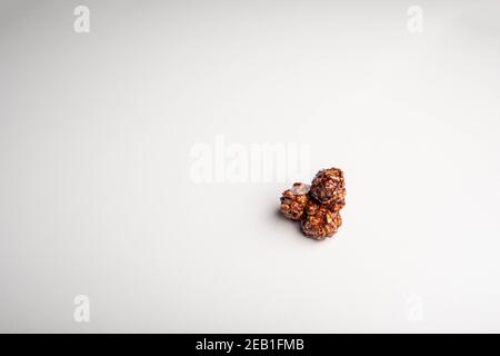 Chocolate popcorn on a white background. Stock Photo