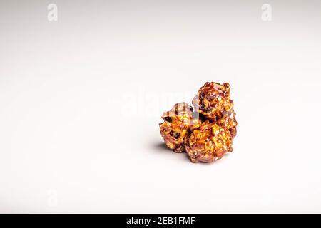 Chocolate popcorn on a white background. Stock Photo
