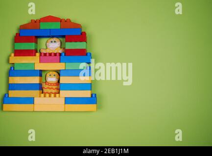 A toy house made from a construction kit with gingerbread man residents quarantined during the coronavirus pandemic. Stock Photo