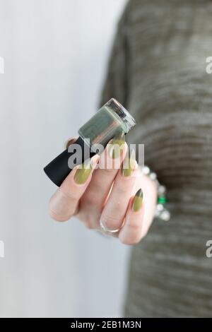 Woman s Hand With Long Nails And Dark Green Nail Polish Stock Photo Alamy