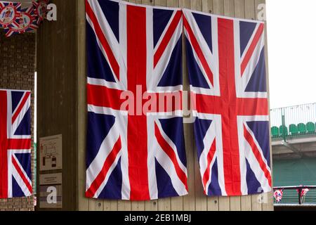 two union jack flags hang on the wall Stock Photo