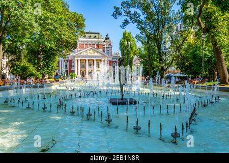 SOFIA, BULGARIA, SEPTEMBER 2, 2018: People are enjoyingg sunny summer day next to the fountain in front of the Ivan Vazov theatre in Sofia, Bulgaria Stock Photo