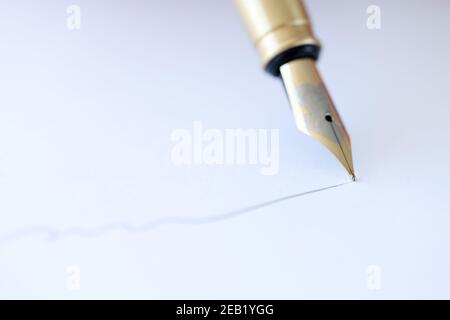 With fountain pen write on white sheet of paper Stock Photo