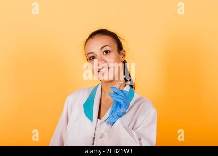 Female medical professional scientist researcher holding a syringe injection, jab vaccination, cure discovery Stock Photo