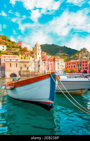 Fishing boat in Vernazza - Cinque Terre on the mountain near mediterranean sea in liguria - Italy. Sunny cloudy sky. Traditional italian architecture Stock Photo