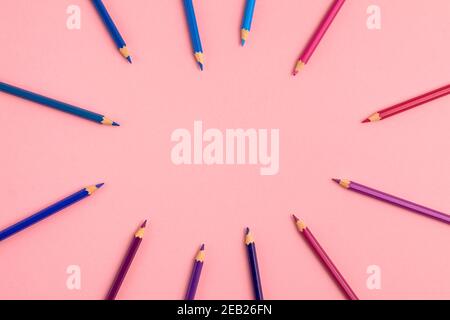 Pencils of pink dark blue purple colors on pink background. Flat lay top view. Education template back to school and online study concept with copy sp Stock Photo