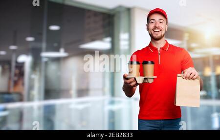 Courier is happy to deliver hot coffee and food to home Stock Photo