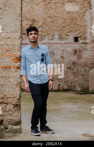 Young Hispanic man on vacation visiting famous ancient ruins - Young traveler enjoying his vacation in Antigua Guatemala Stock Photo