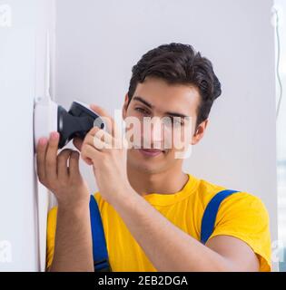 The contractor installing surveillance cctv cameras in office Stock Photo