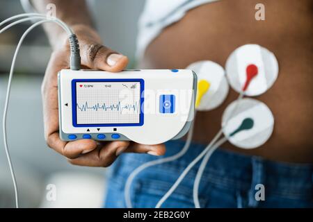 African American Patient Using Electrodes Diagnostic Device Stock Photo