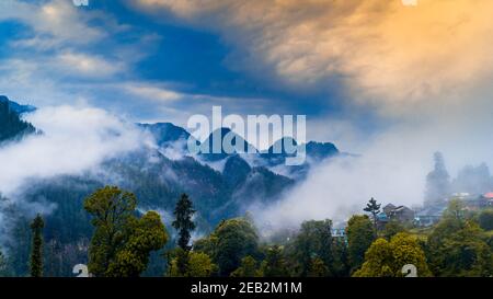 Scenic view in the Himalayan range. Sunrise view from the dense forest of Himalayan village Grahan, Kasol, Himachal Pradesh, India. Stock Photo