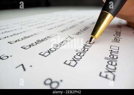 Close-up view of completing an evaluation form Stock Photo