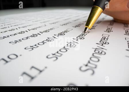 Close-up view of completing a questionnaire Stock Photo