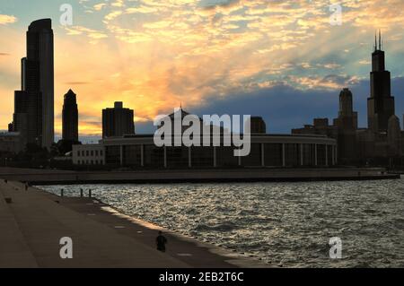 Chicago, Illinois, USA. The sun sets beyond the Shedd Aquarium as seen from the city's Museum Campus. Stock Photo