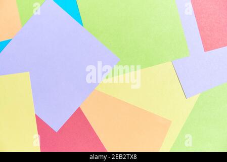 Colorful background: square sheets of paper of different colors filling the frame. Office or school supplies, for taking notes or for making origami o Stock Photo