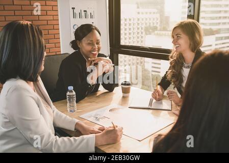 Happy diverse businesswoman leaders in meeting room Stock Photo