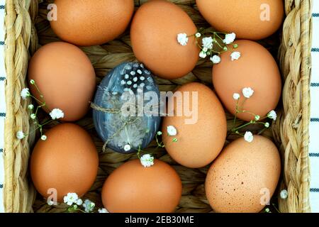 Zero waste concept. No plastic concept. Minimal style. Beige water hyacinth box with brown chicken eggs on textile background. Stock Photo