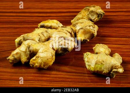 Raw and medicinal plant root Ginger pieces on the table Stock Photo