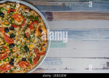 Pizza with vegetable ingredients on wooden background, copy space Stock Photo