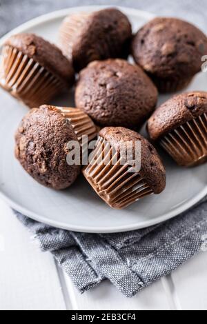 Chocolate muffins. Sweet dark cupcakes on plate. Stock Photo