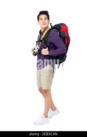 Isolated Portrait of handsome young attractive asian tourist man in casual attire carrying backpack and camera, studio shot white background Stock Photo