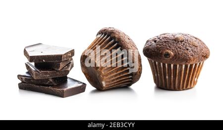 Chocolate muffins and chocolate bars. Sweet dark cupcakes isolated on white background. Stock Photo