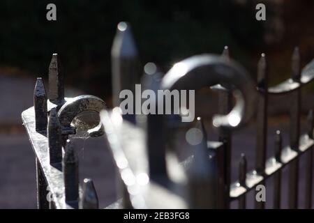 detail of old iron railings near a building with two curly end pieces Stock Photo