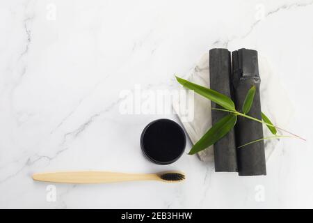 Activated Bamboo charcoal tooth powder on marble background. Stock Photo